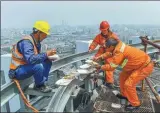  ??  ?? From top right: Workers coordinate steel components in place on Raffles City; steel structure hoisting on Qiantan Center ( 280 meters, 56 floors); Workers have lunch on top of Qiantan Center; Hu Zhimin takes advantage of the work break to take pictures for the workers. on Gao Shang Domain.