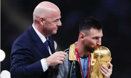  ?? ?? Gianni Infantino presents the World Cup to Lionel Messi after Argentina’s victory in the final against France. Photograph: Alex Livesey/ Danehouse/Getty Images