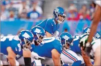  ?? ADAM HUNGER/AP PHOTO ?? New York Giants quarterbac­k Eli Manning looks over the defense during the first half of a preseason game against the New York Jets on Thursday .