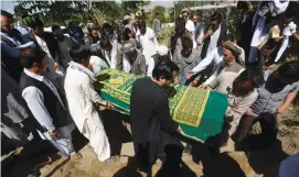  ?? (Omar Sobhani/Reuters) ?? AFGHANS TAKE part in a burial ceremony of Afghan journalist Zabihullah Tamanna outside Kabul yesterday.