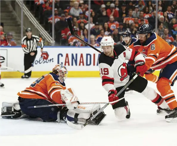  ?? IAN KUCERAK ?? New Jersey Devils forward Travis Zajac scores on Oilers goalie Mikko Koskinen Wednesday night at Rogers Place. The Devils beat the Oilers 6-3, after having lost seven in a row and being outscored 16-6 in their past three games.