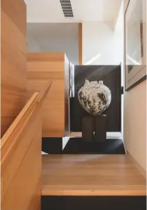  ??  ?? Below, a Moon Jar sculpture by Japanese ceramicist Akiko Hirai is displayed in an alcove – ‘almost like a little gallery for one piece of work’ – in the Victorian ash staircase that leads to the main bedroom