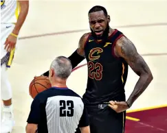  ?? Associated Press ?? ■ Cleveland Cavaliers' LeBron James argues a call with referee Jason Phillips during the first half of Game 4 of basketball's NBA Finals against the Golden State Warriors on Friday in Cleveland.