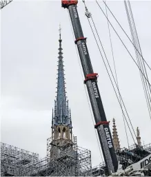  ?? | MOHAMMED BADRA ?? THE new spire of the Notre Dame Cathedral stands beside a giant crane, in Paris. The scaffoldin­g around it was removed in February. EPA-EFE