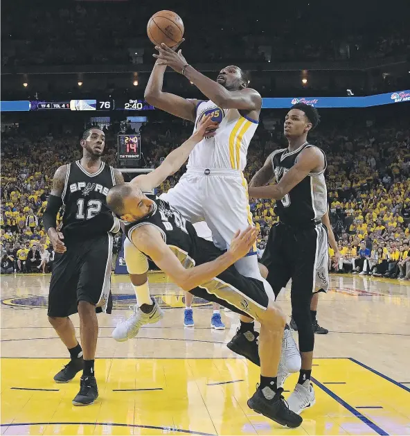  ?? — GETTY IMAGES ?? Golden State Warriors forward Kevin Durant runs over San Antonio Spurs guard Manu Ginobili during Game 1 of the Western Conference final Sunday in Oakland, Calif. Durant had 34 points to help the Warriors rally back late for a 113-111 victory.
