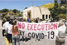  ?? ERIC RISBERG AP ?? People demonstrat­e outside San Quentin State Prison, which had a deadly COVID-19 outbreak in the summer of 2020.