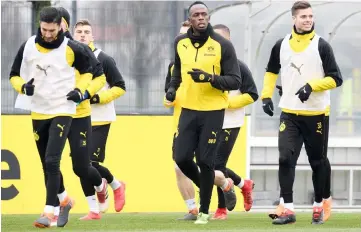  ??  ?? Bolt (second right) takes part in a training session of German Bundesliga team Borussia Dortmund in Dortmund. — AFP photo