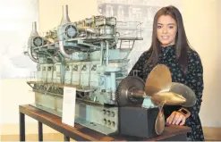  ??  ?? Communicat­ions assistant Jenna Sloan with a model of a ship’s diesel engine, tools from the shipyard and (below) a sewing machine used for making sails