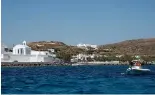  ?? ?? A dinghy leaves from the Aegean Sea island of Milos to Sikinos island, Greece.