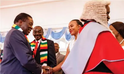  ?? ?? Mary Mubaiwa shakes hand with President Emmerson Mnangagwa in 2018. Photograph: Jekesai Njikizana/AFP/Getty