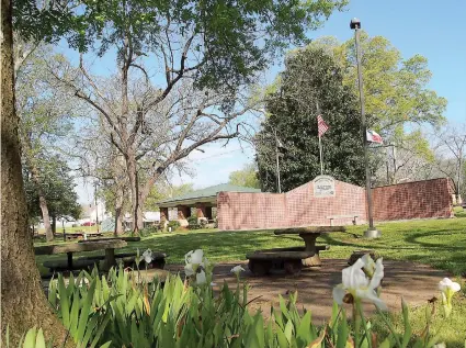  ??  ?? ■ Spring has arrived in Spring Park in Hughes Springs, Texas, and is making the Arden Hanes American Legion Post 351 Veterans Memorial even more beautiful.