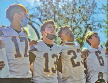  ?? ?? LEFT: (FROM LEFT) Brawley Union High’s Robert Platt; Ethan Gutierrrez, Isaiah Young and Daniel Camillo sing a team chant during a community Bell Game rally on Wednesday in Brawley.