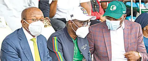  ??  ?? Governor, Central Bank of Nigeria, Godwin Emefiele ( left); Lagos State Governor, Babajide Sanwo- Olu and Minister of Youth and Sports Developmen­t, Sunday Dare at a World Cup qualificat­ion match between the Super Eagles and the Lone Stars of Liberia, at the Teslim Balogun Stadium, Surulere, Lagos… yesterday