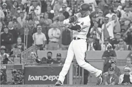  ?? KIRBY LEE/USA TODAY SPORTS ?? Dodgers first baseman Cody Bellinger hits a three-run home run in the eighth inning of Game 3 of the National League Championsh­ip Series against the Braves Tuesday at Dodger Stadium in Los Angeles.