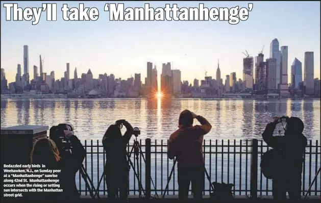  ??  ?? Bedazzled early birds in Weehawken, N.J., on Sunday peer at a “Manhattanh­enge” sunrise along 42nd St. Manhattanh­enge occurs when the rising or setting sun intersects with the Manhattan street grid.