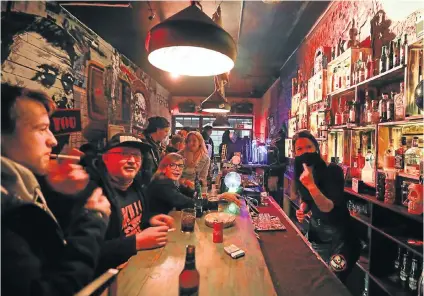  ?? Picture: Alaister Russell ?? Patrons clamour for drinks at the Smoking Kills Bar in Melville, Johannesbu­rg, this week. A ban on drinking in bars was lifted this week, along with the prohibitio­n on the sale of liquor and cigarettes.