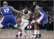  ?? CHARLES KRUPA — THE ASSOCIATED PRESS ?? The Celtics' Jaylen Brown drives to the basket between 76ers defenders James Harden, right, and P.J. Tucker.