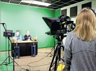  ?? / Alexis Draut ?? Sophomore Andrew Barber, left, and Senior Matthew Turner record Monday morning’s campus announceme­nts at Calhoun High School in the video production studio.