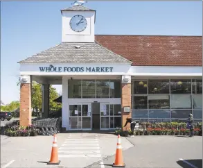  ?? Tyler Sizemore / Hearst Connecticu­t Media ?? Customers wait in line to enter Whole Foods Market in Greenwich on Wednesday.