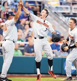  ?? NATI HARNIK/ASSOCIATED PRESS ?? Oregon State’s Tyler Malone (7) celebrates with Adley Rutschman (35) and Michael Attalah (40) after hitting a three-run home run against Mississipp­i State during an NCAA College World Series eliminatio­n game on Saturday.