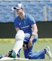  ?? — PTI ?? Australia skipper Steve Smith straps up for a knock in the nets in Pune on Wednesday.