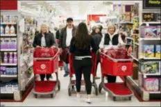  ?? JOHN MINCHILLO — THE ASSOCIATED PRESS ?? Shoppers pack an aisle during a Black Friday sale at a Target store, Friday in Newport, Ky.