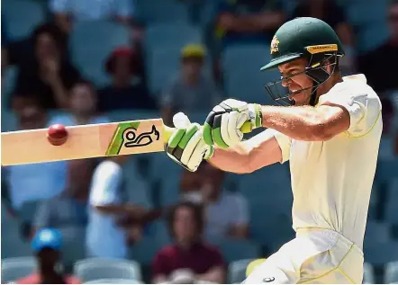  ?? — AFP ?? In pain: Australia skipper Tim Paine is racing against time to recover from a sore right finger to play in the second Test against India at the Perth Stadium on Friday.