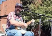  ??  ?? Lane House of Adairsvill­e plays his antique banjo while conducting a banjo workshop during Fiddlin’ Fest. / Doug Walker