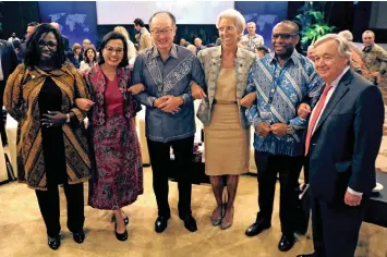  ?? | Reuters ?? WORLD Bank vice-president and corporate secretary (left to right) Yvonne Tsikata; Indonesia’s Finance Minister Sri Mulyani Indrawati; World bank president Jim Yong Kim; IMF managing director Christine Lagarde; deputy governor of the South African Reserve Bank, Daniel Mminele; and UN secretary-general Antonio Guterres ahead of the Developmen­t Committee Meeting at the Internatio­nal Monetary Fund – World Bank Group Annual Meeting 2018 in Nusa Dua, Bali, Indonesia, on Saturday.