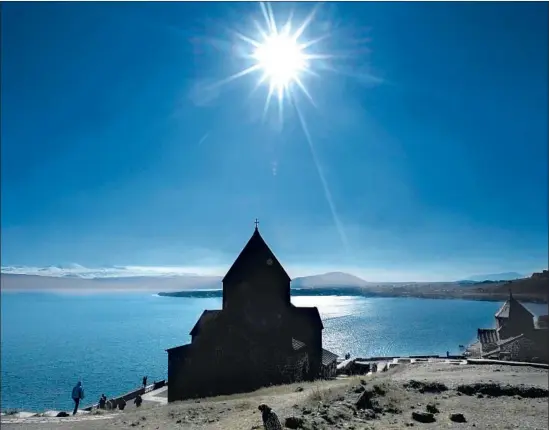  ?? Kirill Kudryavtse­v AFP / Getty Images ?? THE SUN provides a dazzling backdrop for an ancient church beside Sevan Lake in Armenia. It’s one of two stone churches in the Sevanavank Monastery complex.