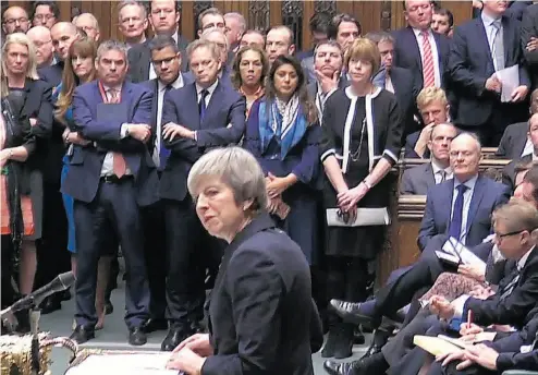  ?? AFP PHOTO / GETTY IMAGES ?? British Prime Minister Theresa May speaks to the House of Commons in London Monday, when she announced that the Brexit bill will be deferred on a day of high drama — including a rogue Labour MP grabbing the ceremonial mace.