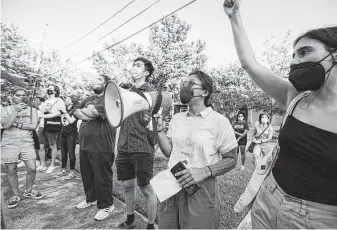  ?? Annie Mulligan / Contributo­r ?? Royal Sumikat leads chants at a protest in June. The tenants union acts as a consultant of sorts, explaining the law, which strategies might be used and how renters can connect with one another.