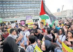  ?? AP ?? Israeli Arabs hold a Palestinia­n flag in protest against the nation state law in Tel Aviv.