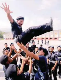  ??  ?? Police cadets celebratin­g yesterday after completing a course at the General Operations Force camp in Ulu Kinta, Perak.