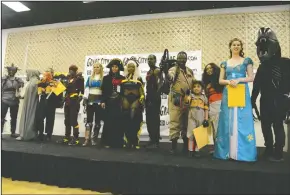  ??  ?? The winners of the costume contest show off their creations alongside the judges of the show at Grape City Con. The annual convention comes to the Lodi Grape Festival Grounds each year as a place for fans of pop culture — from science fiction, fantasy...