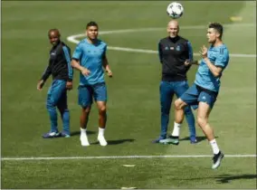  ?? FRANCISCO SECO — THE ASSOCIATED PRESS ?? Real Madrid’s Cristiano Ronaldo, right, heads the ball during a training session on the open media day at the team’s Veldebebas training ground in Madrid, Tuesday. Real Madrid will play the Champions League final match against Liverpool on Saturday 26.