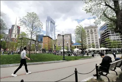 ?? AP/ELISE AMENDOLA ?? Visitors stroll and pause Wednesday in Boston Common, the nation’s oldest city park. Developers’ plans for a skyscraper nearby have raised complaints that it would violate the state’s shadow law.