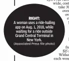  ?? (Associated Press file photo) ?? RIGHT:A woman uses a ride-hailing app on Aug. 1, 2018, while waiting for a ride outside Grand Central Terminal inNew York.