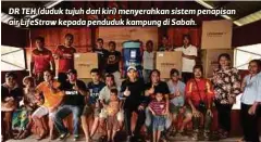  ??  ?? DR TEH (duduk tujuh dari kiri) menyerahka­n sistem penapisan air LifeStraw kepada penduduk kampung di Sabah.