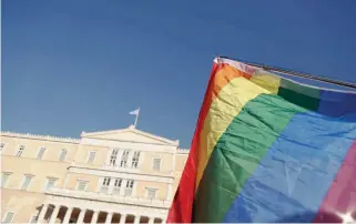  ??  ?? A rainbow flag – a symbol of the lesbian, gay, bisexual and transgende­r community – is seen yesterday outside Parliament, where MPs debated a bill that would allow people to change their gender identity without sex change surgery.