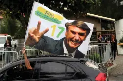  ?? (Sergio Moraes/Reuters) ?? A SUPPORTER of Brazil’s new president-elect, Jair Bolsonaro, celebrates yesterday in Rio de Janeiro.