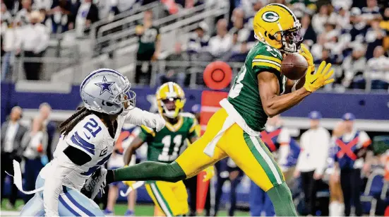  ?? Michael Ainsworth/Associated Press ?? Packers receiver Dontayvion Wicks, right, makes a touchdown catch in front of Cowboys cornerback Stephon Gilmore. It was Dallas’ first home loss since 2022.