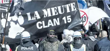  ?? GRAHAM HUGHES/THE CANADIAN PRESS ?? Police hold back far-right protesters during a demonstrat­ion in Montreal in March.