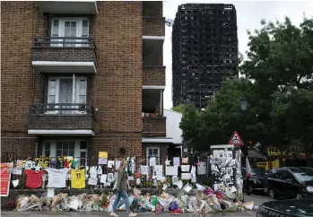  ?? Daniel Leal-Olivas / AFP; photos by Stephen Lock for the National ?? Clockwise from far left, flames engulf Grenfell Tower in June; the burnt-out shell; floral tributes near the scene of the blaze; the ‘Truth Wall’; and faded pictures of the missing