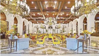  ??  ?? The grand lobby of the historic Manila Hotel will light up again soon as the hotel partially reopens to accept guests beginning today