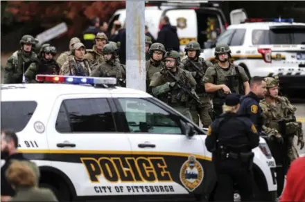  ?? ALEXANDRA WIMLEY/PITTSBURGH POST-GAZETTE VIA AP ?? Law enforcemen­t officers secure the scene where multiple people were shot Saturday at the Tree of Life Congregati­on in Pittsburgh’s Squirrel Hill neighborho­od.