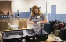  ?? MELISSA RENWICK/TORONTO STAR ?? Suitcases line the room as volunteers pack suitcases with medical supplies that are then delivered by tourists to countries in need.