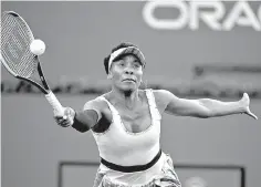  ?? AP Photo/Mark J. Terrill ?? ■ Venus Williams returns a shot to Angelique Kerber on Thursday at the BNP Paribas Open in Indian Wells, Calif.