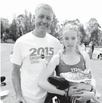  ??  ?? Taneka Moore of Drouin is congratula­ted on receiving the Gippsland Athletics young female athlete award from sponsor Peter Nicholson.