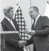  ?? ASSOCIATED PRESS ?? US Secretary of State John Kerry, left, and Russian Foreign Minister Sergey Lavrov, right, shake hands after their meeting in Geneva, Switzerlan­d, Friday, resolving a number of issues towards restoring a nationwide truce to Syria, and opening up aid...